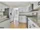 Well-equipped kitchen with white cabinets, granite countertops, stainless steel appliances, and hardwood floors at 355 Woodbyne Dr, Fayetteville, GA 30214