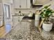 Granite kitchen countertop with gas range and white cabinets, offering a functional and stylish cooking space at 355 Woodbyne Dr, Fayetteville, GA 30214