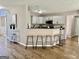 Open kitchen featuring bar stool seating, white cabinets, and hardwood flooring at 355 Woodbyne Dr, Fayetteville, GA 30214