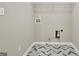 A utility room with herringbone tile floor, grey walls, and washer/dryer hookups at 355 Woodbyne Dr, Fayetteville, GA 30214