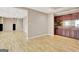 Open living room with wood-look flooring, neutral walls, and a wet bar at 355 Woodbyne Dr, Fayetteville, GA 30214