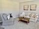 Cozy living room featuring a comfortable sofa, patterned armchair, and stylish decor, creating a relaxing ambiance at 355 Woodbyne Dr, Fayetteville, GA 30214