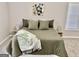 Serene main bedroom featuring muted green bedding, calming artwork, and natural light at 355 Woodbyne Dr, Fayetteville, GA 30214