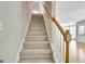 Carpeted staircase with wood railing, connecting floors with natural light and elegant design at 355 Woodbyne Dr, Fayetteville, GA 30214