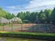Community Tennis Courts behind fence at 355 Woodbyne Dr, Fayetteville, GA 30214