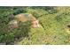 Aerial view displays the wooded lot, surrounding landscape and location of home at 74 Riverwood Trl, Grantville, GA 30220