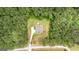 Aerial view of a wooded lot with a house, long driveway, and a private backyard at 74 Riverwood Trl, Grantville, GA 30220