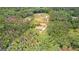 Drone shot shows the house nestled in a heavily wooded lot, offering privacy at 74 Riverwood Trl, Grantville, GA 30220