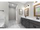 Modern bathroom featuring a double vanity with gray cabinets and marble-patterned tile flooring at 74 Riverwood Trl, Grantville, GA 30220