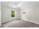 Bright bedroom with plush carpeting, a ceiling fan, and a window that offers natural light, creating a peaceful ambiance at 74 Riverwood Trl, Grantville, GA 30220