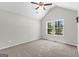 Bright bedroom with vaulted ceiling and a large window overlooking the backyard at 74 Riverwood Trl, Grantville, GA 30220