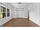 Elegant dining room with modern lighting, wainscoting, and large windows for natural light at 74 Riverwood Trl, Grantville, GA 30220