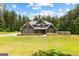 Charming two-story home with gray siding, wood accents, and landscaped front yard at 74 Riverwood Trl, Grantville, GA 30220