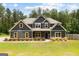 Charming two-story home with gray siding, wood accents, and landscaped front yard at 74 Riverwood Trl, Grantville, GA 30220