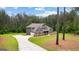 Beautiful two-story home features lush backyard, long driveway, and attached garage at 74 Riverwood Trl, Grantville, GA 30220