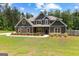 Charming two-story home with gray siding, wood accents, and landscaped front yard at 74 Riverwood Trl, Grantville, GA 30220