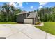Large, paved driveway leads to a two-car garage in this two-story home at 74 Riverwood Trl, Grantville, GA 30220