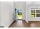 Bright foyer features wood-look floors, a blue front door, and high ceilings at 74 Riverwood Trl, Grantville, GA 30220