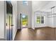 Bright foyer with an open door view, showcasing hardwood floors and abundant natural light at 74 Riverwood Trl, Grantville, GA 30220