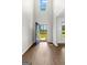 Bright foyer features wood-look floors, a blue front door, and high ceilings at 74 Riverwood Trl, Grantville, GA 30220