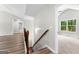 Upstairs hallway with wood floors leading to bedrooms and bathrooms, filled with light at 74 Riverwood Trl, Grantville, GA 30220