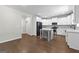 Bright eat-in kitchen features white cabinetry, stainless appliances, an island, and hardwood floors at 74 Riverwood Trl, Grantville, GA 30220