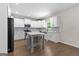 Bright kitchen features white cabinetry, stainless appliances, gray backsplash, and an island at 74 Riverwood Trl, Grantville, GA 30220