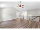 Open living room featuring a ceiling fan and stylish hardwood flooring with natural light throughout at 74 Riverwood Trl, Grantville, GA 30220