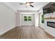 Bright living room with hardwood floors and a modern fireplace beneath a wall-mounted TV at 74 Riverwood Trl, Grantville, GA 30220