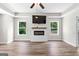 Bright living room with hardwood floors and a modern fireplace beneath a wall-mounted TV at 74 Riverwood Trl, Grantville, GA 30220