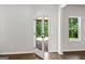 Bright room featuring hardwood floors, an exit doorway and large window, seamlessly blending indoor and outdoor spaces at 74 Riverwood Trl, Grantville, GA 30220