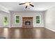 Comfortable living area with a brick fireplace, ceiling fan, and plenty of natural light at 74 Riverwood Trl, Grantville, GA 30220