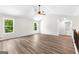 Bright living room with hardwood floors, large windows, and an open staircase at 74 Riverwood Trl, Grantville, GA 30220