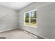 Bright walk-in closet with ample white wire shelving and a view to the backyard at 74 Riverwood Trl, Grantville, GA 30220