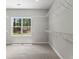 Spacious walk-in closet with white wire shelving and a window offering natural light at 74 Riverwood Trl, Grantville, GA 30220