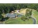Expansive property featuring a large house, horse arena, and outbuildings surrounded by lush greenery at 135 Brookshire Dr, Fayetteville, GA 30215