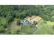 Aerial view of the home's exterior, with a long drive, horse paddock, and sprawling green space at 135 Brookshire Dr, Fayetteville, GA 30215