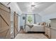 Bedroom with a wooden sliding closet door, a bed and a nightstand at 135 Brookshire Dr, Fayetteville, GA 30215