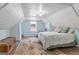 Bright bedroom featuring sloped ceilings, hardwood floors, and a comfortable bed at 135 Brookshire Dr, Fayetteville, GA 30215