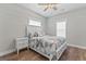 Bright bedroom with a ceiling fan, wood floors, and a white bed and nightstands at 135 Brookshire Dr, Fayetteville, GA 30215