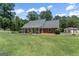 Beautiful exterior of the brick home with a lush green lawn at 135 Brookshire Dr, Fayetteville, GA 30215