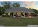 Charming brick home featuring a welcoming porch with rocking chairs at 135 Brookshire Dr, Fayetteville, GA 30215