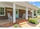 Inviting front porch with rocking chairs and a brick facade at 135 Brookshire Dr, Fayetteville, GA 30215