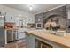 Bright kitchen featuring white cabinets, butcher block countertops, and stainless steel appliances at 135 Brookshire Dr, Fayetteville, GA 30215