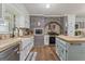 Charming kitchen with white cabinets, butcher block countertops, stainless steel appliances and brick accent wall at 135 Brookshire Dr, Fayetteville, GA 30215
