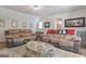 A living room features two reclining sofas, an ottoman, hardwood floors and a small window at 135 Brookshire Dr, Fayetteville, GA 30215