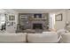 Cozy living room showcasing a brick fireplace, comfortable sofa, and hardwood floors at 135 Brookshire Dr, Fayetteville, GA 30215