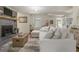 Open living space with a brick fireplace, plush seating, and staircase access at 135 Brookshire Dr, Fayetteville, GA 30215