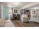 Inviting living room featuring hardwood floors, stylish furnishings, and a decorative brick fireplace at 135 Brookshire Dr, Fayetteville, GA 30215