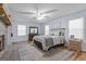 Bright main bedroom features a ceiling fan, a bed, dresser, and hardwood floors at 135 Brookshire Dr, Fayetteville, GA 30215